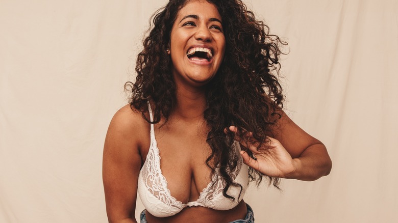 smiling woman in white lace bra