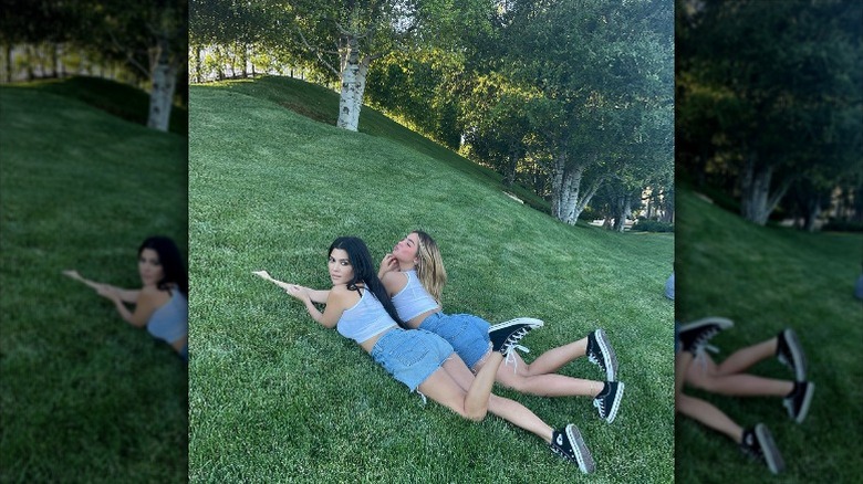 Kourtney Kardashian and Addison Rae wearing Converse in the grass