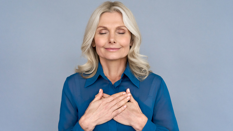 woman smiling holding hands 