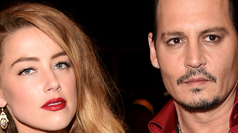 Amber Heard and Johnny Depp pose on the red carpet