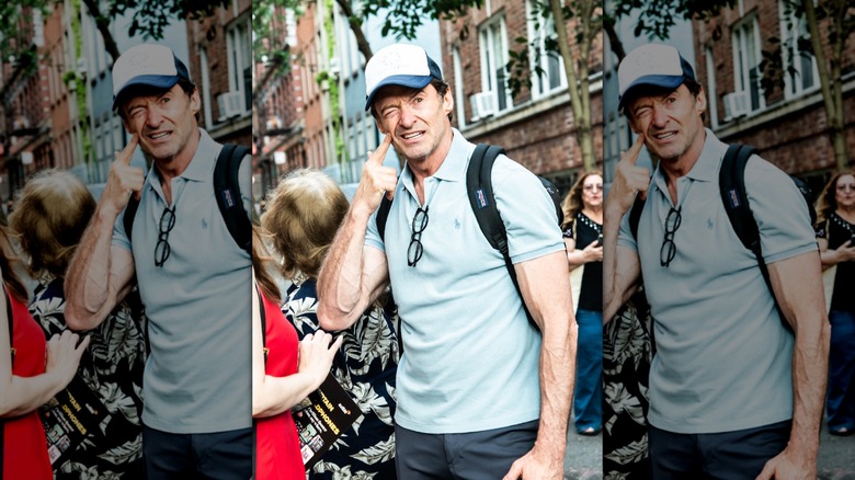 Hugh Jackman looking confused while poking cheek