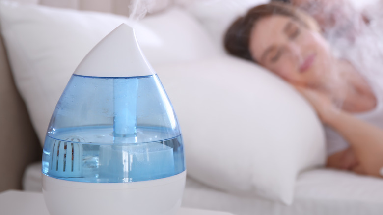Woman sleeping with air humidifier on