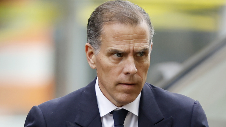 Hunter Biden looking left while frowning in a grey suit