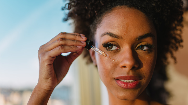 Woman applying face oil