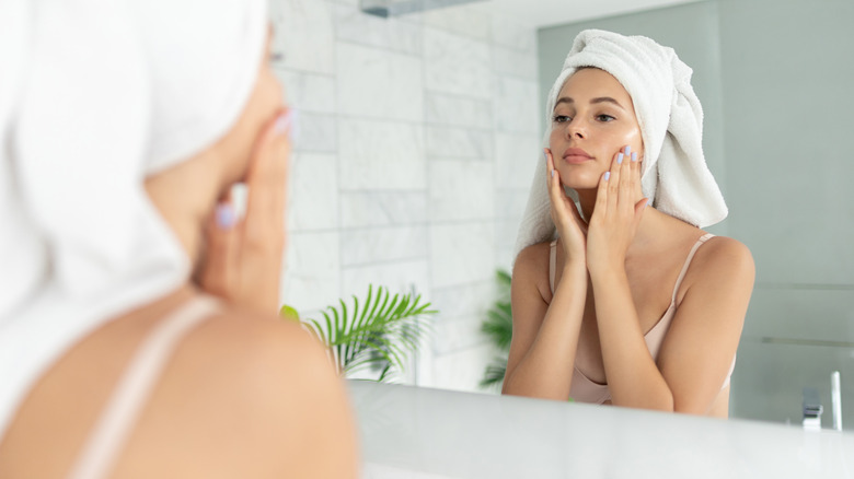 Woman applying product to face