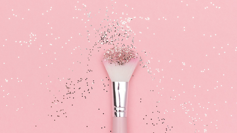 Makeup brush on pink background