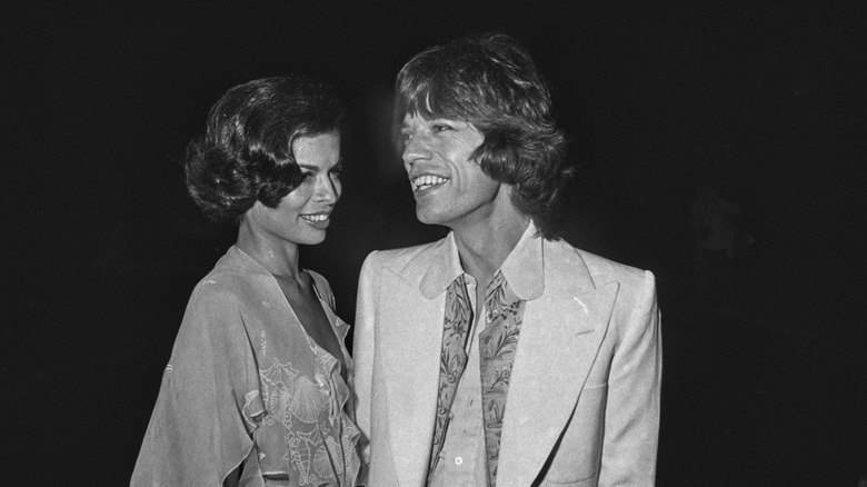Bianca Jagger and Mick Jagger smile for a photo in 1973