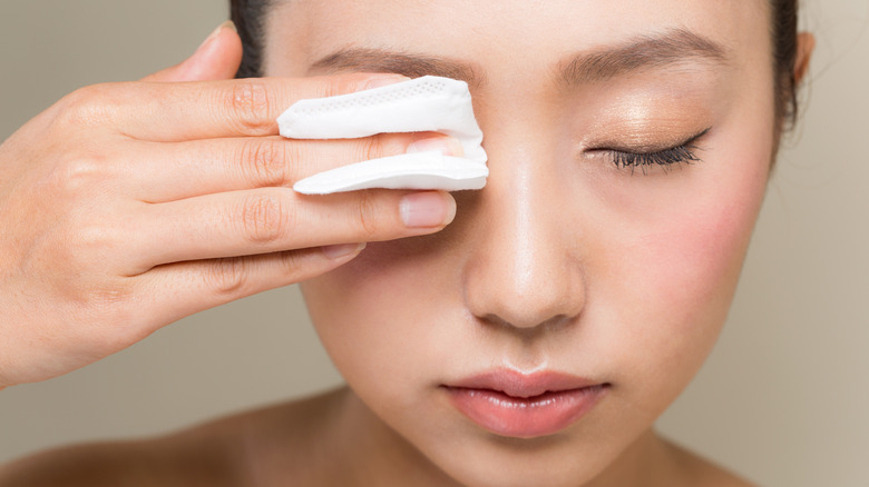 woman removing makeup