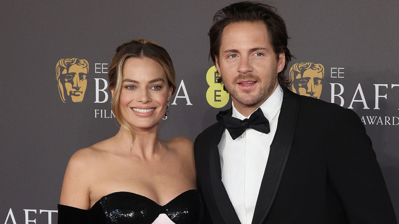 Margot Robbie and Tom Ackerley smiling