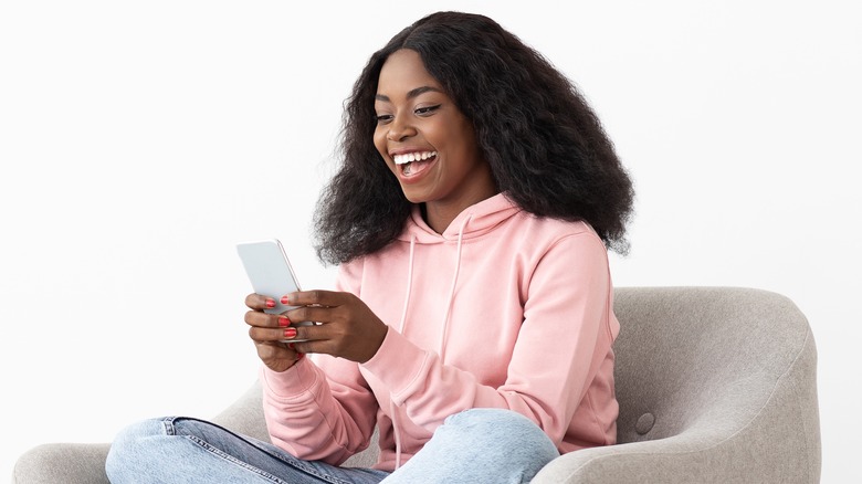 woman laughing at phone