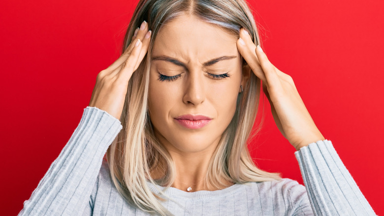 Young woman experiencing a migraine