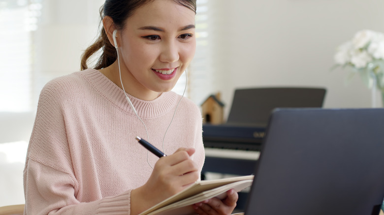 Woman taking notes while learning