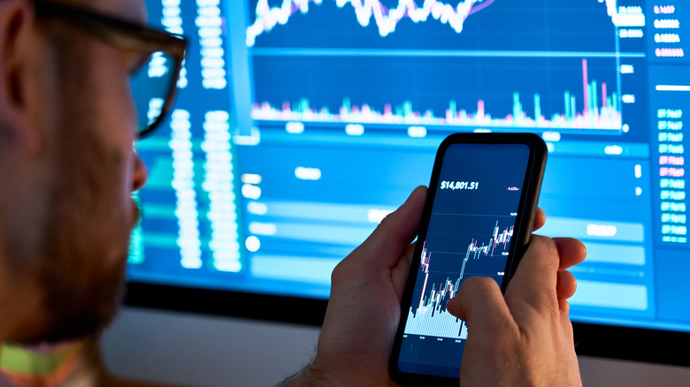 Man investing on his phone