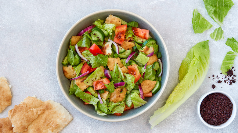 Healthy salad with greens, poultry, and tomatoes