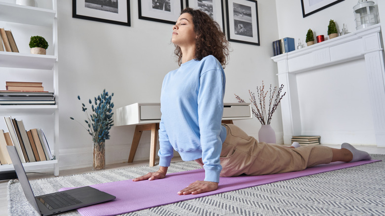 woman doing yoga at home