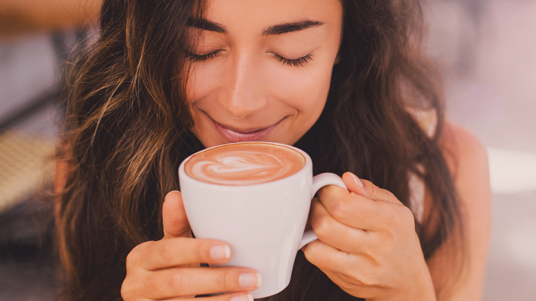 Young woman enjoying a cup of coffee 