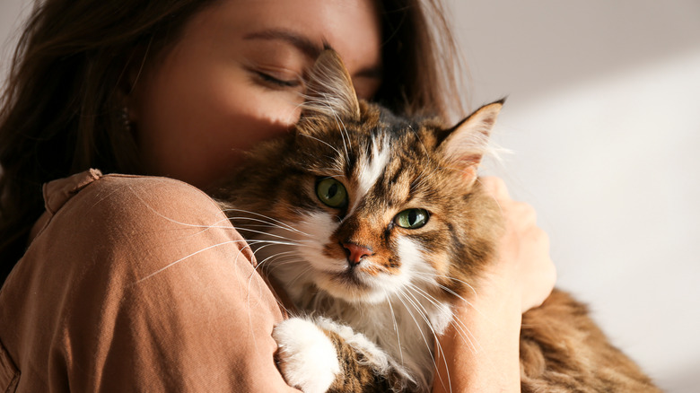 A woman cuddling with a cat 