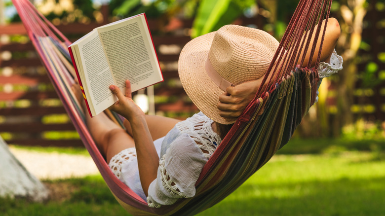 woman in a hammock reading a book
