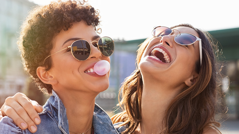 Two friends laughing with sunglasses