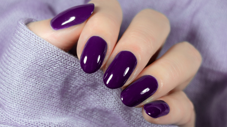 Woman wearing purple nails