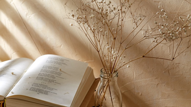 book open on a table outside with fall decor