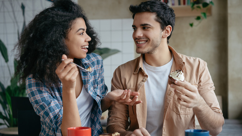 Couple eating cupcakes on date