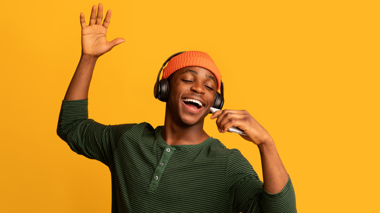 Man singing along while listening to music