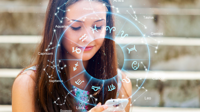 Woman looking at phone with star signs surrounding 