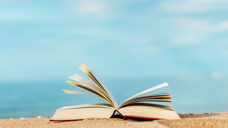 book on a sandy beach