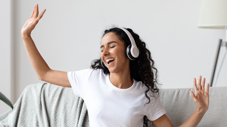 Woman with headphones on singing