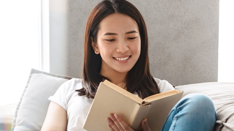 Woman reads happily