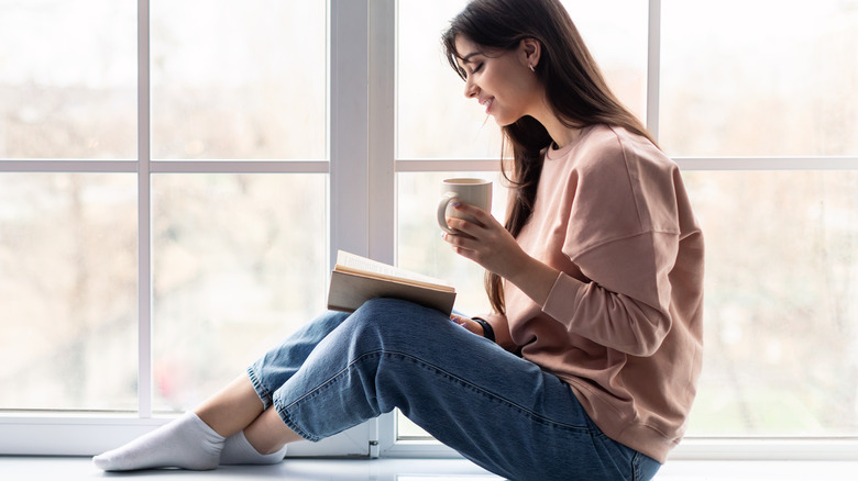 Woman sitting and reading a book
