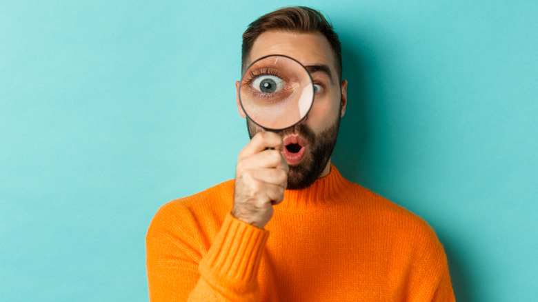 A man with a magnifying glass