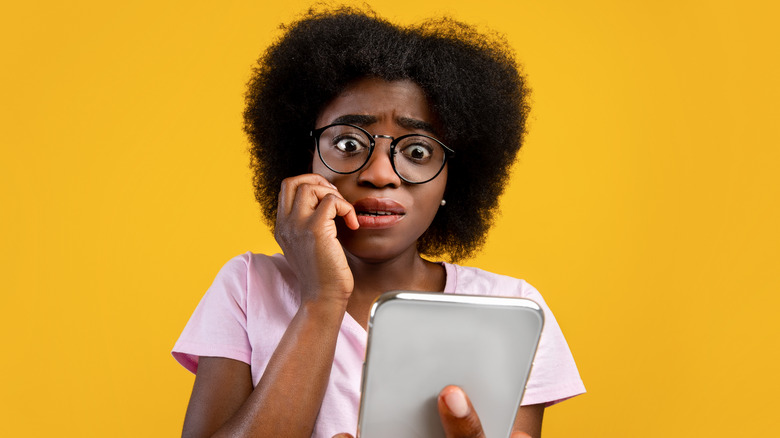 Young woman with scared reaction