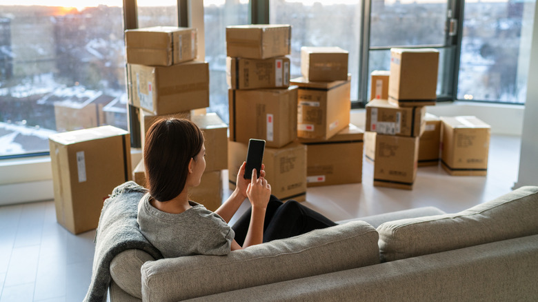Woman in her apartment with moving boxes