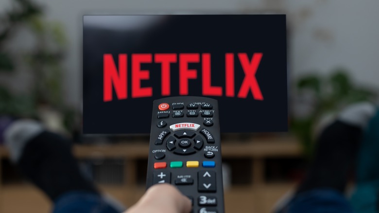 Netflix logo on a TV screen with remote