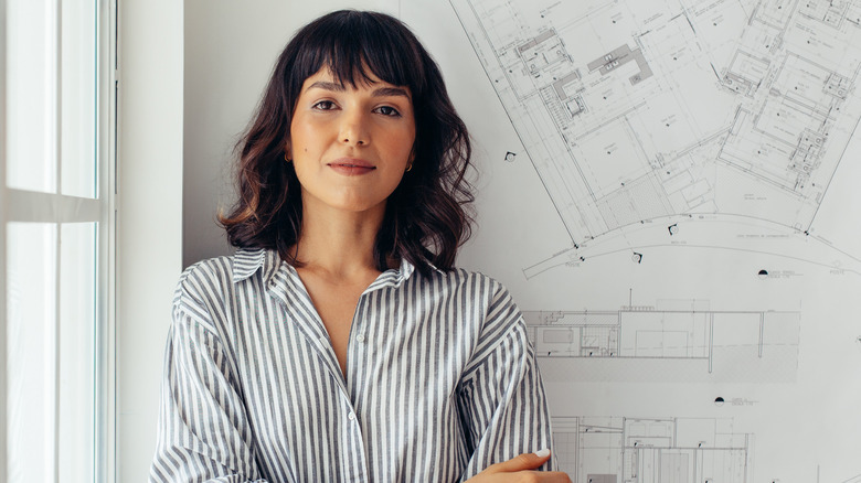 Woman standing in front of plans