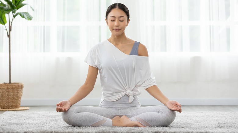 Woman meditating on the floor