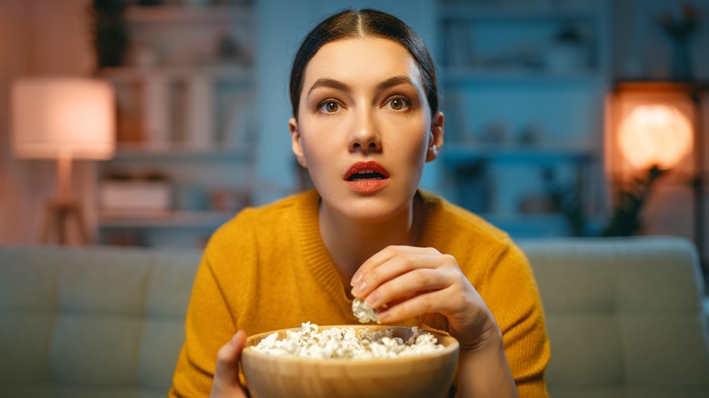 A woman watching television.