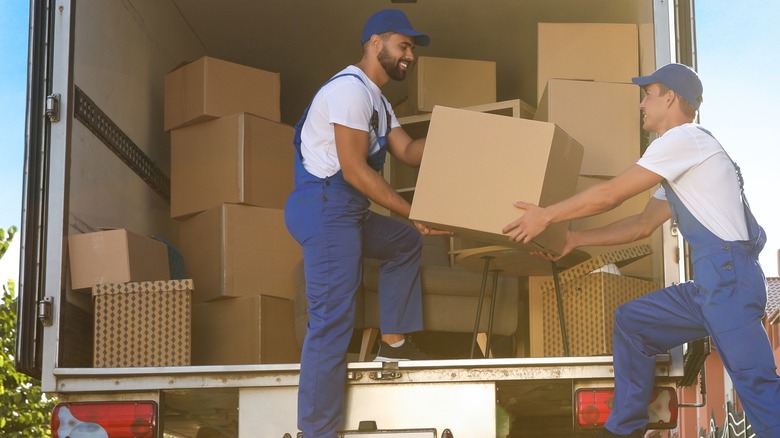 Movers putting boxes in a truck