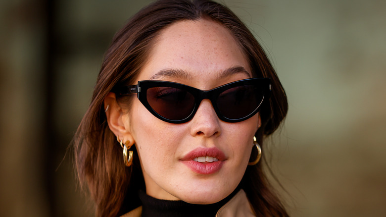 model wearing cat-eye sunglasses