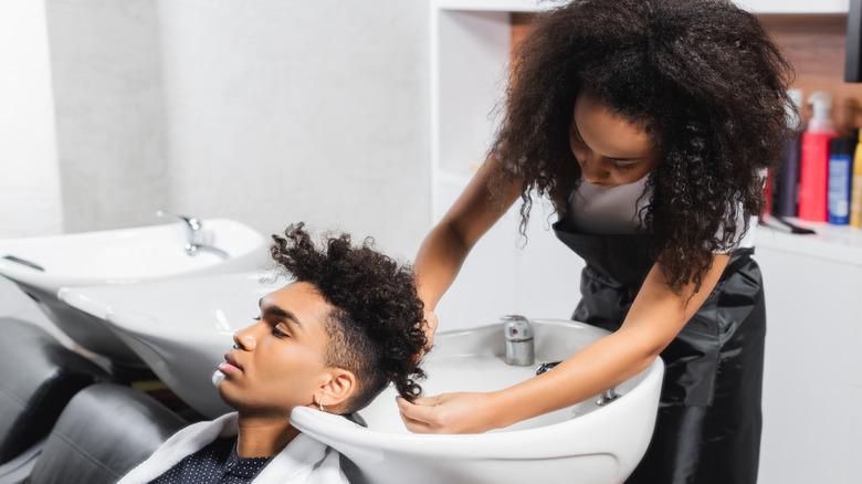 hairstylist washing clients hair