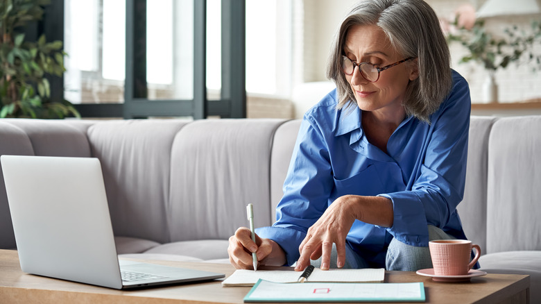 woman on her computer writing 