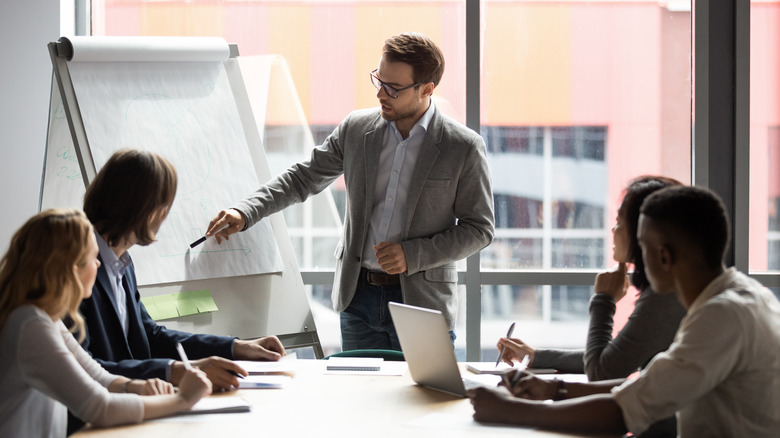 man presenting in a board meeting