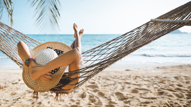 Woman relaxing in hammock 