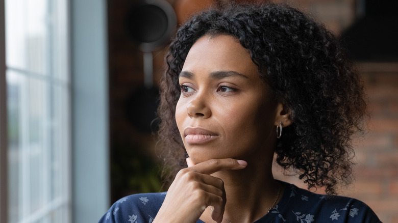 woman thinking looking out window