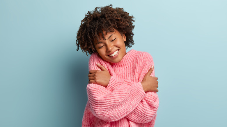 A woman hugging herself