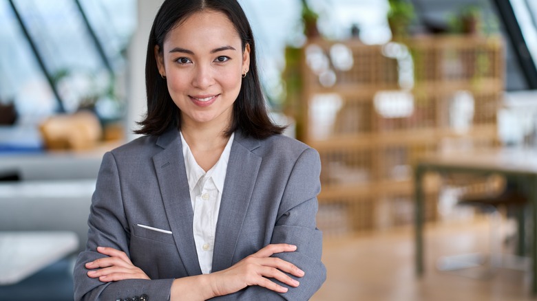 Woman in suit smiling confidently