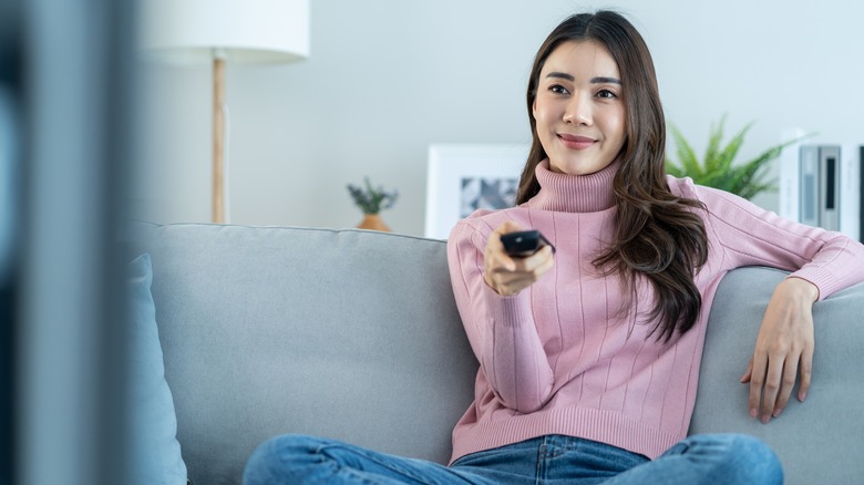 A woman watching TV