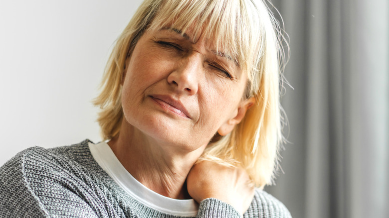 Woman suffering from neck pain